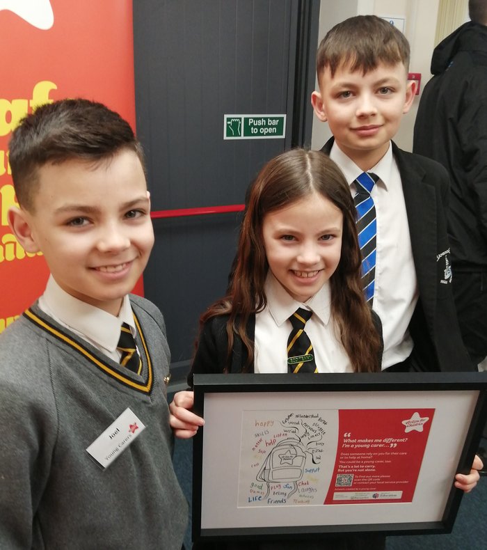 Aaron, Joel and Kesiah with the Young Carers poster