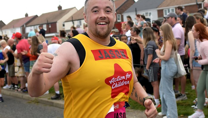 Male runner in yellow Action for Children vest