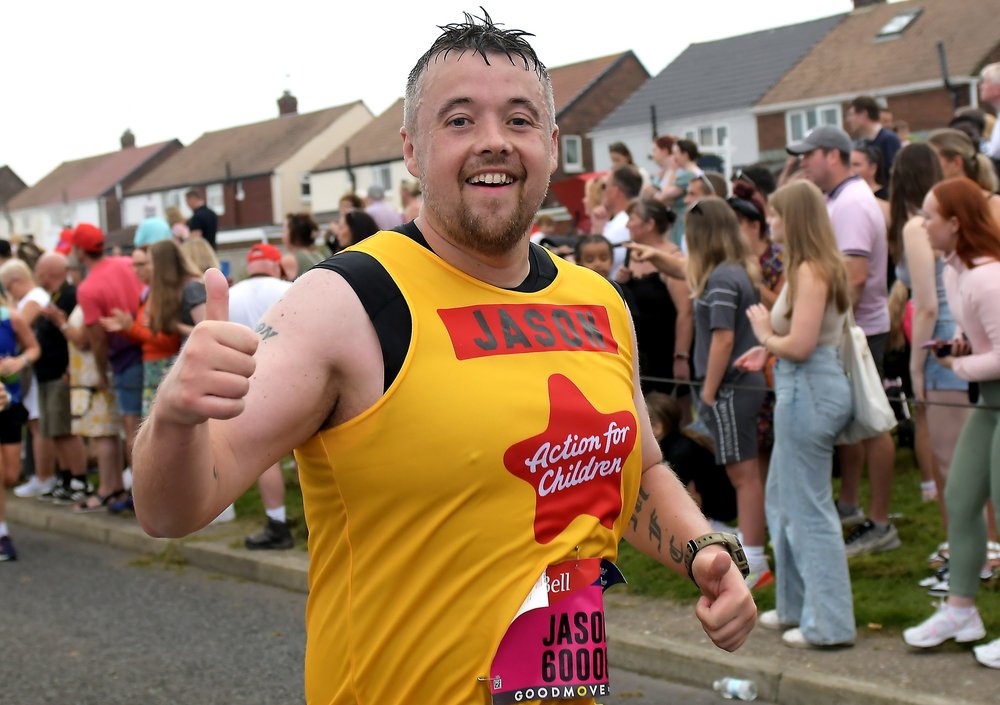 Male runner in yellow Action for Children vest