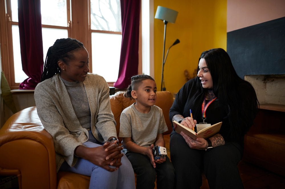 Action for Children worker talking with child in home