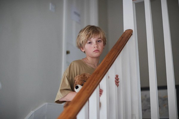 Young boy on stairs in care home
