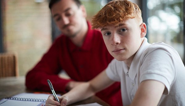 Young person in care studying with their carer