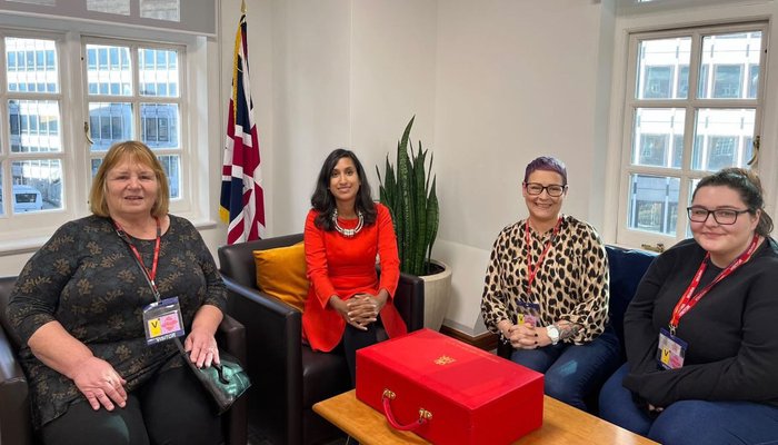 Anne Marie Connelly and colleagues sitting at an office table at Action for Children