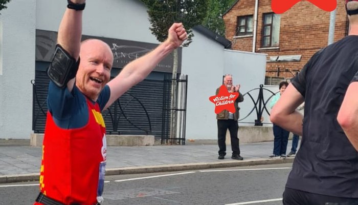 Belfast Marathon - Man running with hands up and Action for Children T-shirt