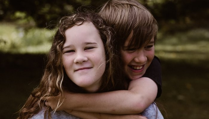 Boy hugging girl outside