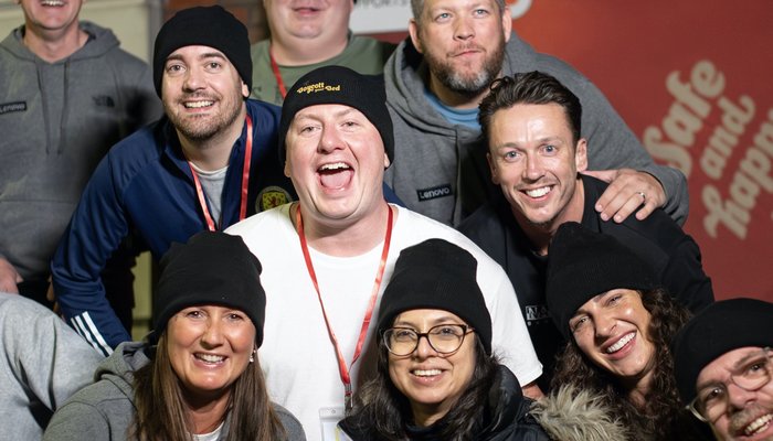 Group of people laughing and smiling at a Boycott your Bed event