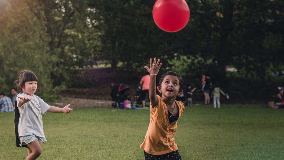 children playing with red balloon