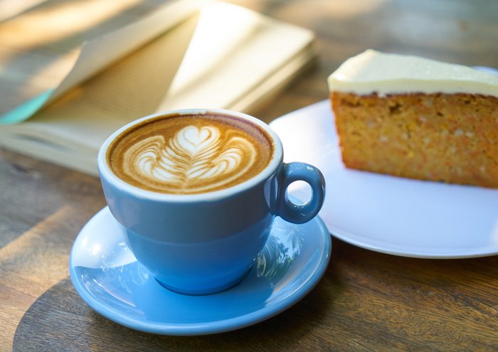 Close up shot of coffee and a slice of cake
