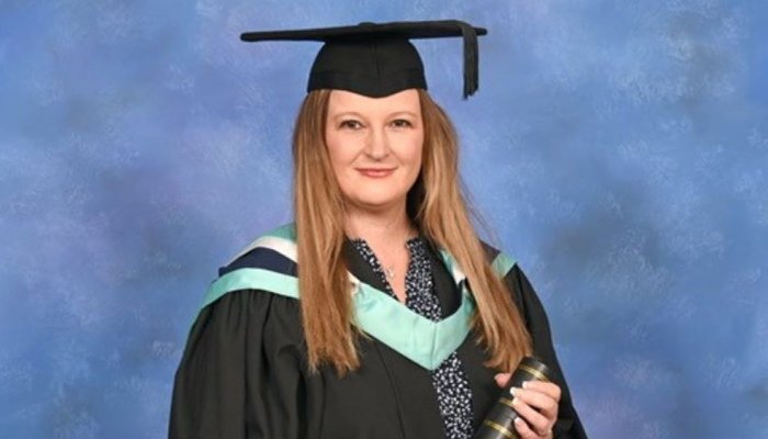 Corinna Laing at graduation with scroll