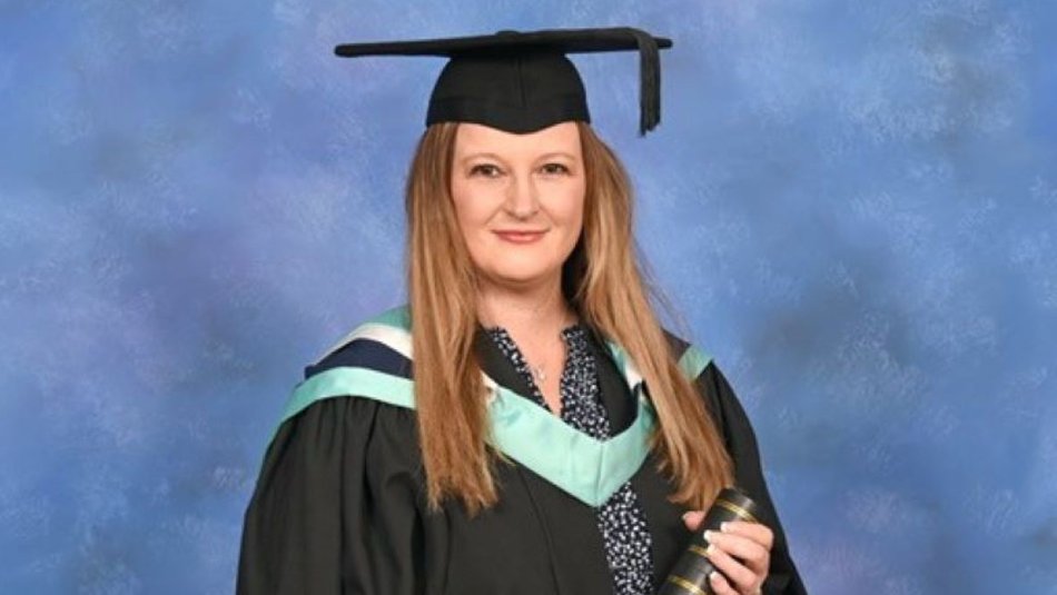 Corinna Laing at graduation with scroll