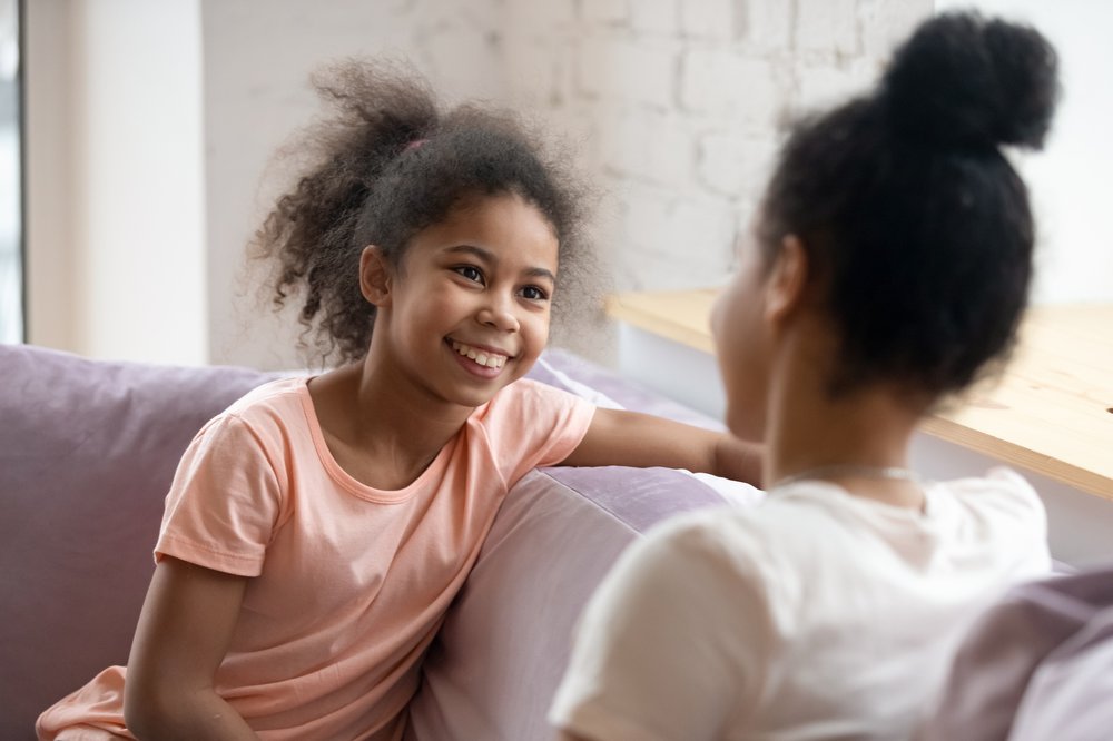 daughter and mother talking on couch