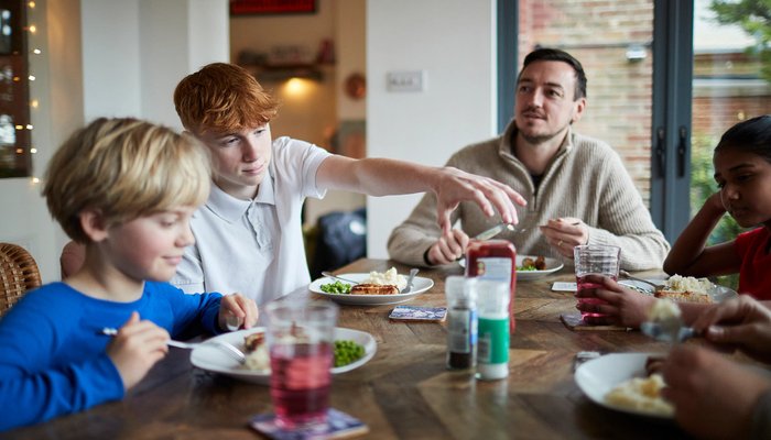 Family gathered around table having lunch