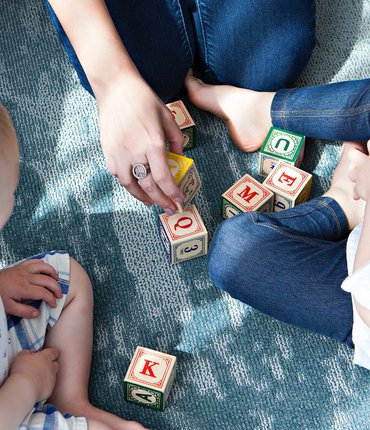 Family playing with letter blocks