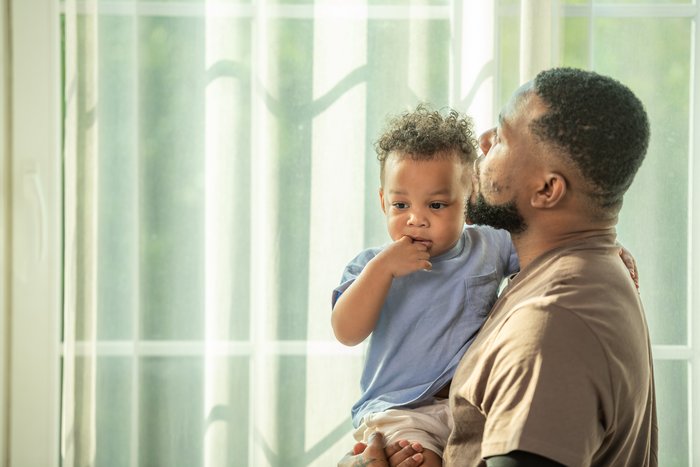 Father holding son looking into distance