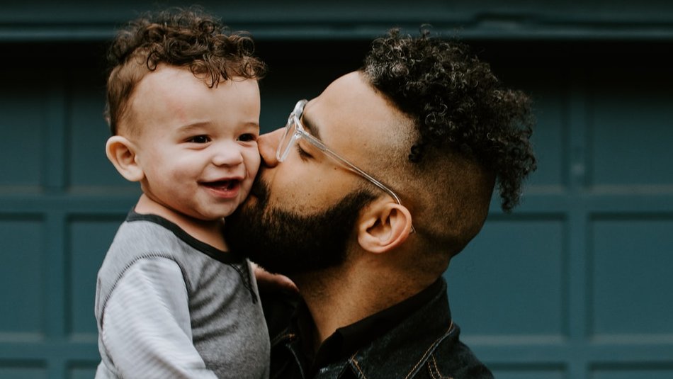 Father kissing toddler