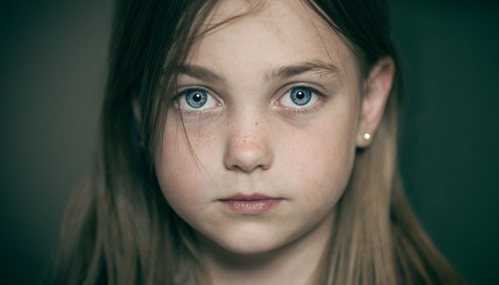 Serious girl looking at camera cropped