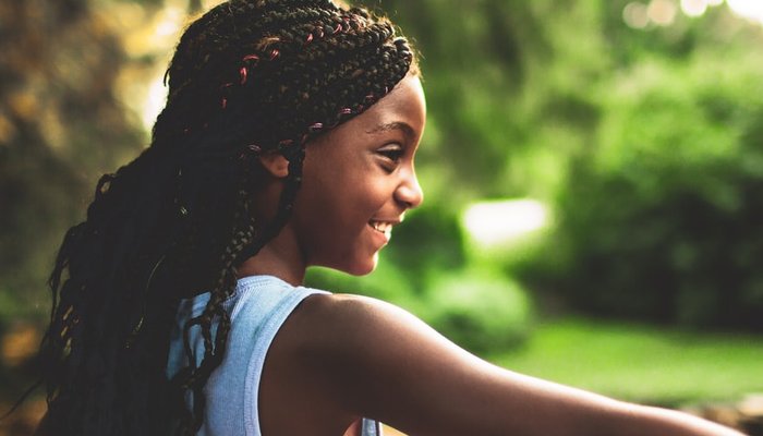 Girl with long hair standing outside in the garden