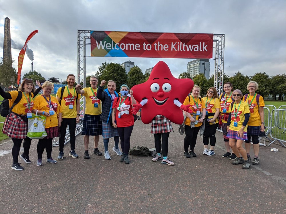 Group of Action for Children fundraisers at Kiltwalk with mascot Cosmo
