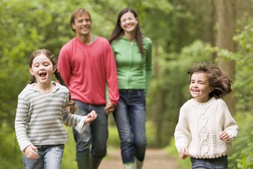 Happy family walking in woods