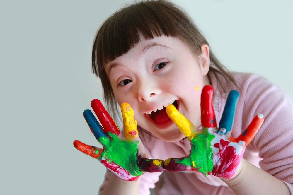 Happy girl with painted hands