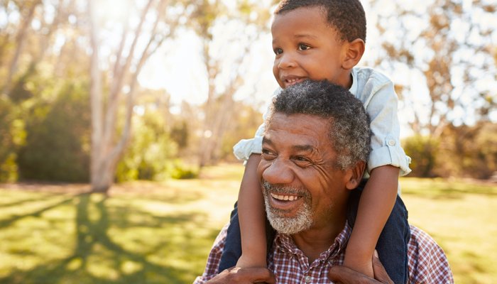 Happy grandfather with toddler boy sitting on his shoulders.jpg