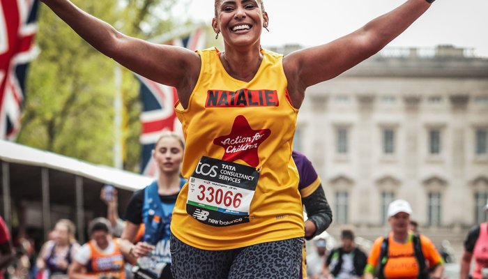 Female runner at London Marathon in yellow vest