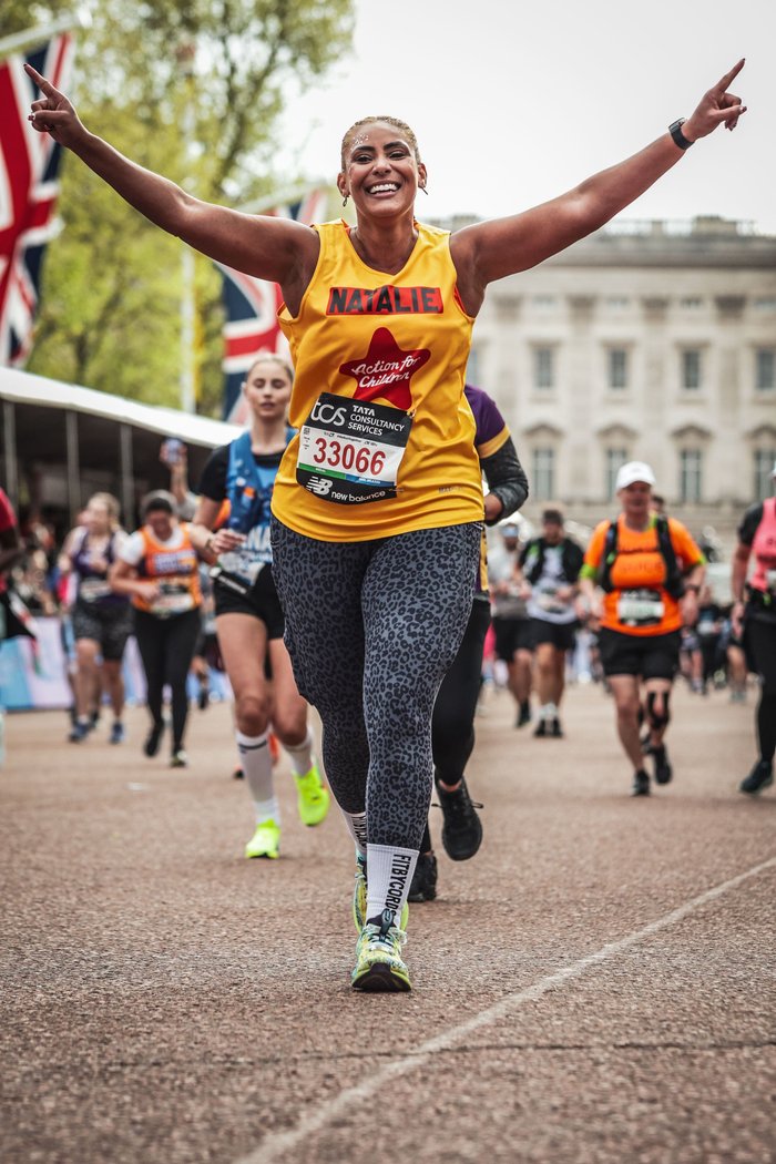 Female runner at London Marathon in yellow vest