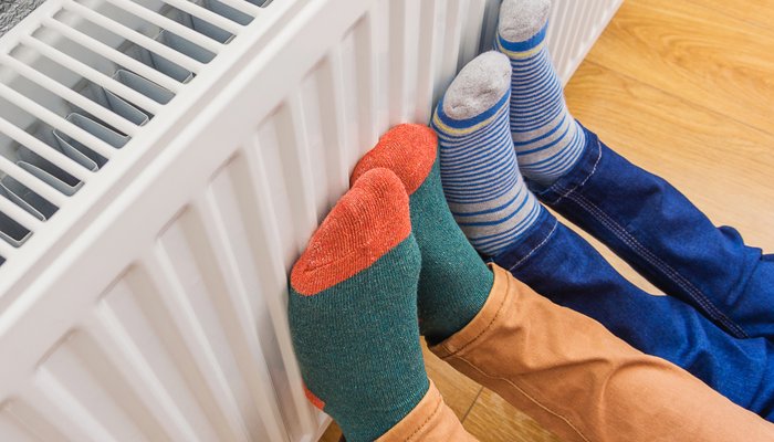 Children's feet warming up on a radiator