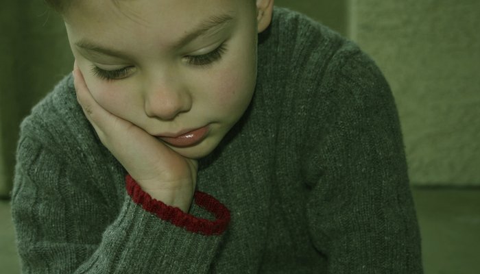 Boy in a sweater looking down