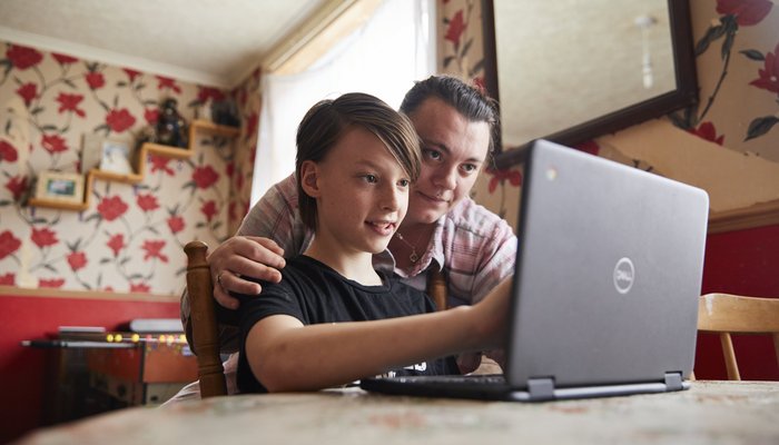 Jacob with his mother looking at his Dell laptop