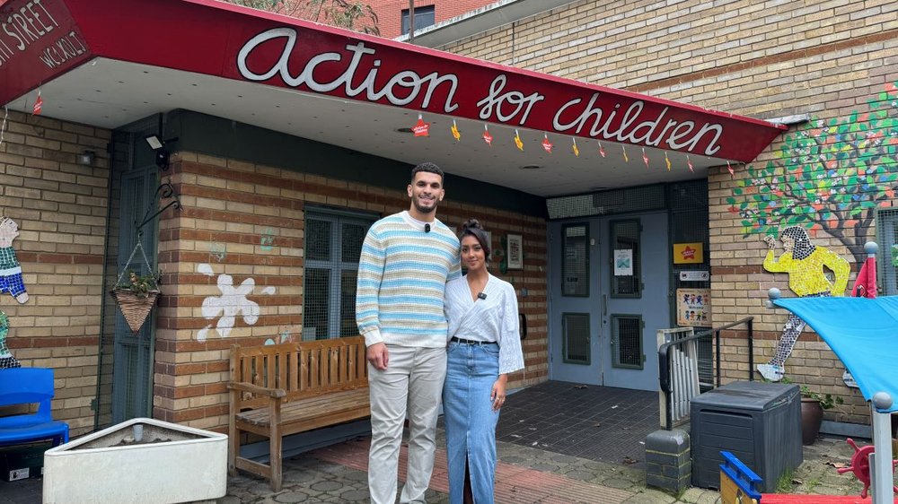 Kai and Sannam standing outside Action for Children centre