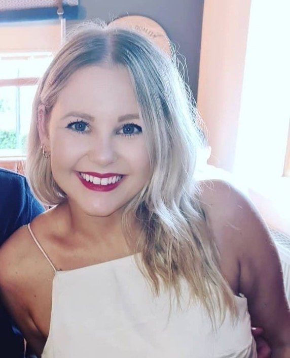 Young woman with a white top smiling