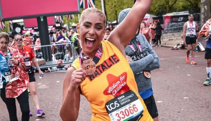 Action for Children runner called Natalie smiling with medal at the end of the London Marathon