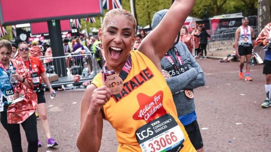 Action for Children runner called Natalie smiling with medal at the end of the London Marathon
