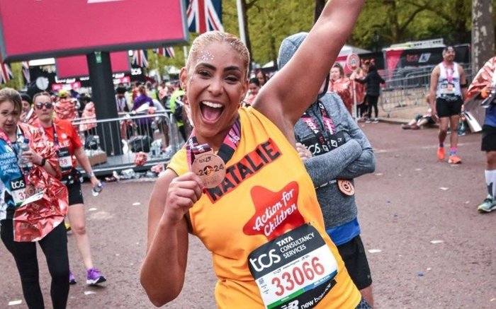 Action for Children runner called Natalie smiling with medal at the end of the London Marathon