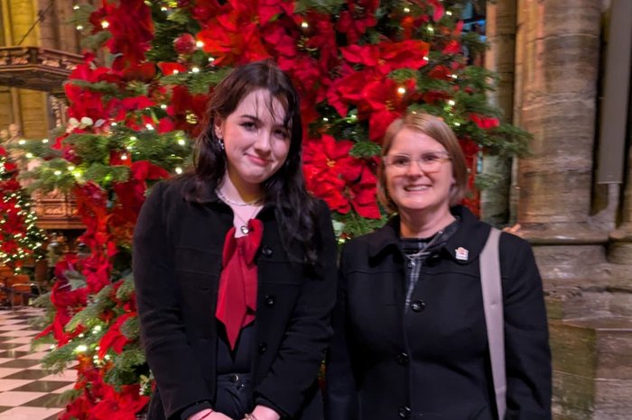 Meghan, a young carer with her support AfC worker Vikki at the Christmas carol concert 2025