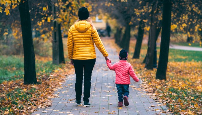 Mother and daughter walking in park