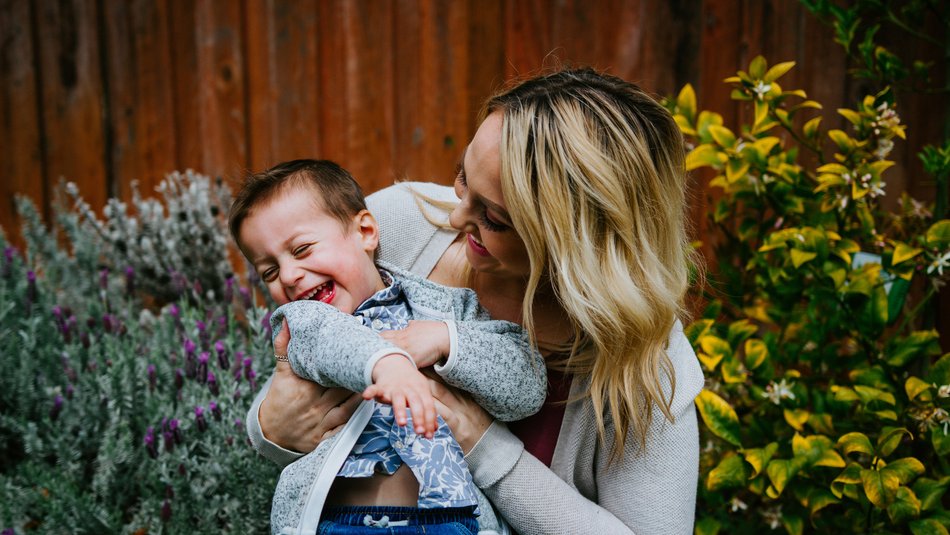 Mother and son laughing together in a garden