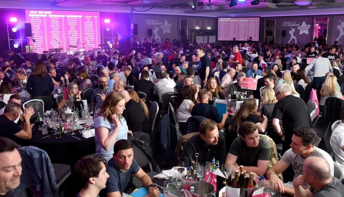 Guest seated at tables at the Never Mind the Business event