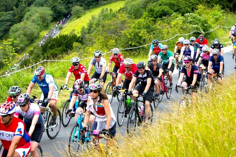 Ride London cyclists passing through hilly park