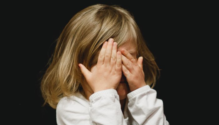 Sad girl covering eyes