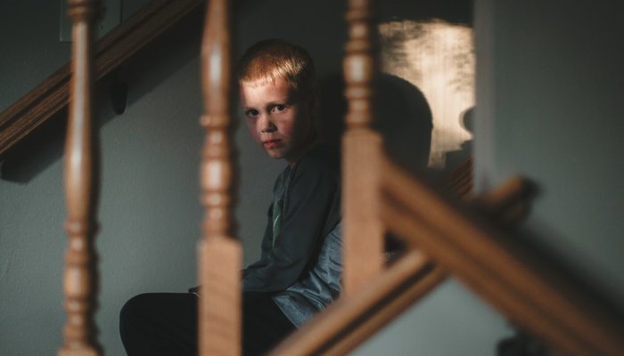 Scared boy on staircase