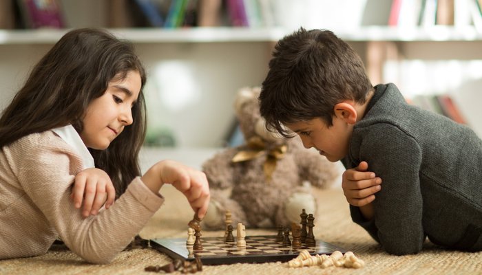 Siblings playing chess