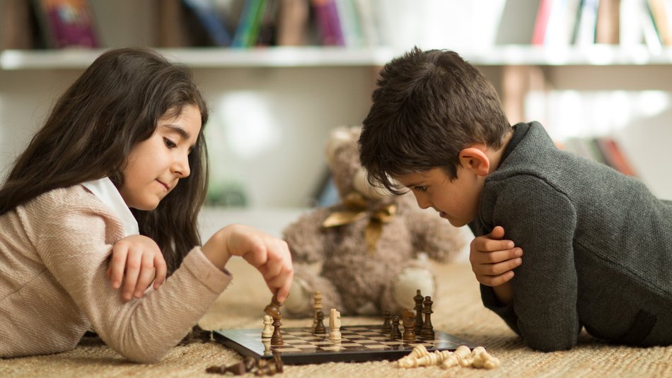 Siblings playing chess