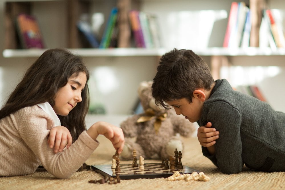 Siblings playing chess