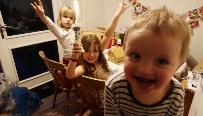 Thomas with his two older sisters at Christmas