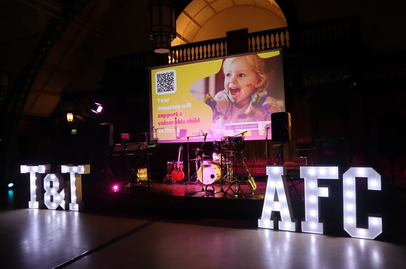 Turner_and_Townsend letters next to AFC letters on stage