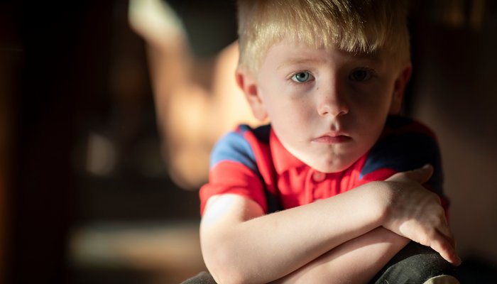 Young boy crossing arms