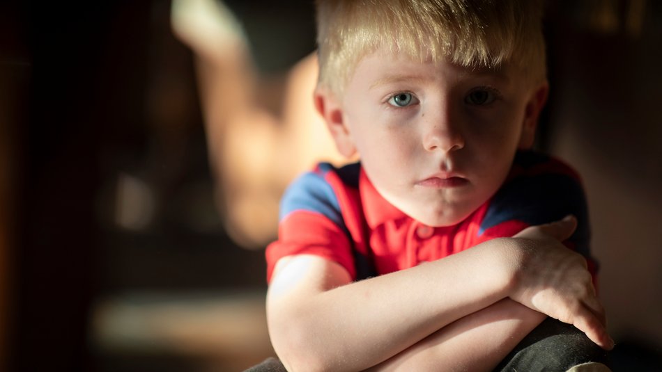 Young boy crossing arms