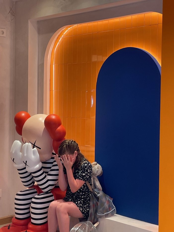 Young foster child visiting the museum imitating a big toy